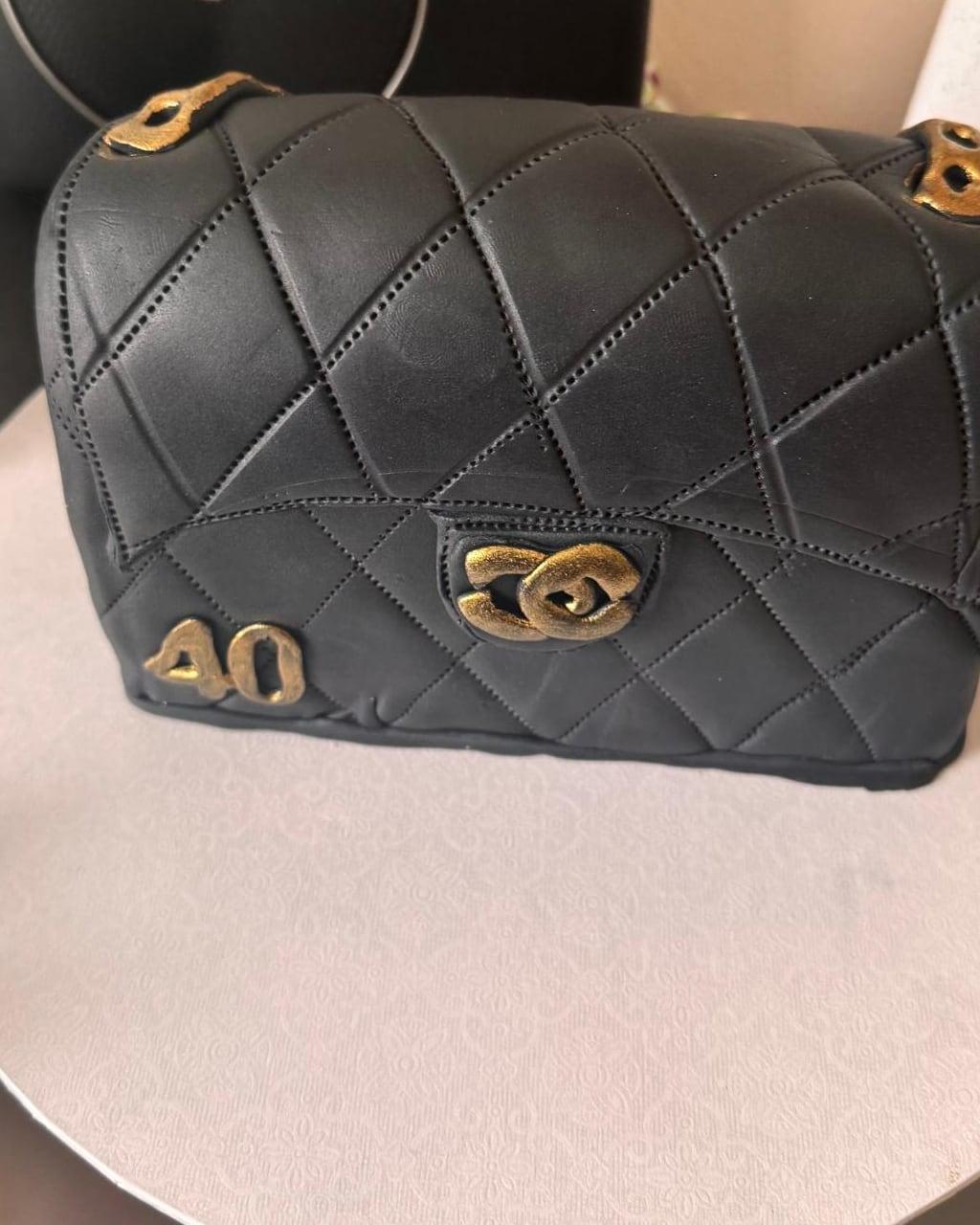 A hand-sculpted quilted handbag cake with gold hardware and a gilded forty
